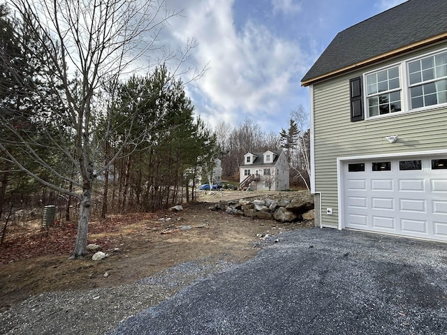 view of side of home with a garage