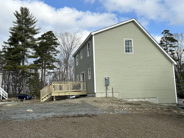 view of side of property featuring a deck