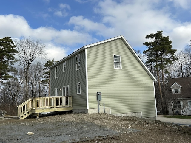 view of side of home featuring a wooden deck