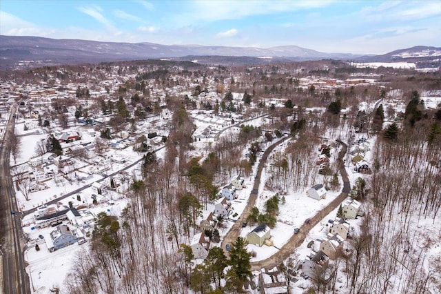 snowy aerial view with a mountain view