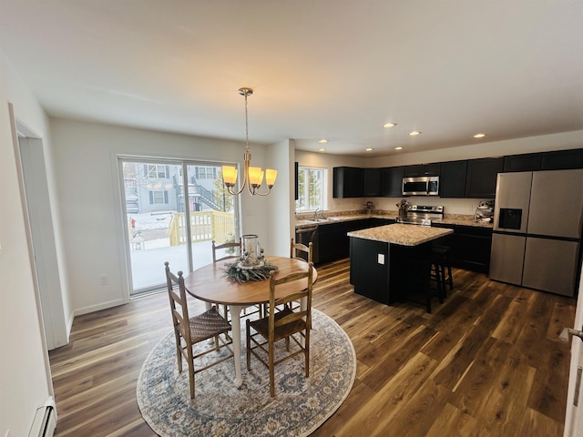 dining space featuring baseboards, a baseboard radiator, recessed lighting, dark wood-type flooring, and a chandelier