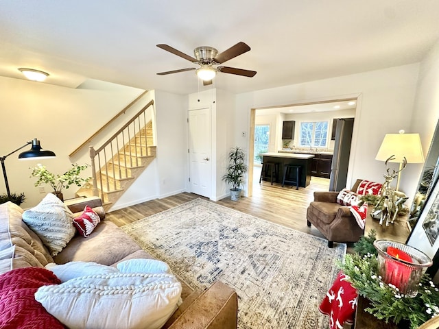 living room with wood-type flooring and ceiling fan