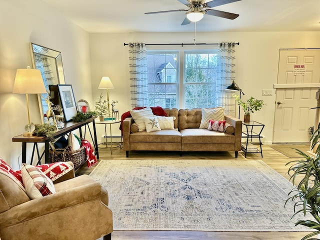 living room featuring a baseboard radiator, hardwood / wood-style floors, and ceiling fan