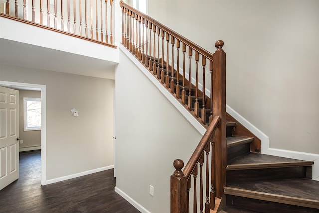 stairs featuring hardwood / wood-style floors and a baseboard radiator