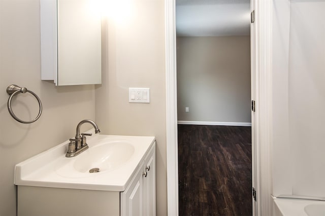 bathroom with hardwood / wood-style floors, vanity, and a textured ceiling