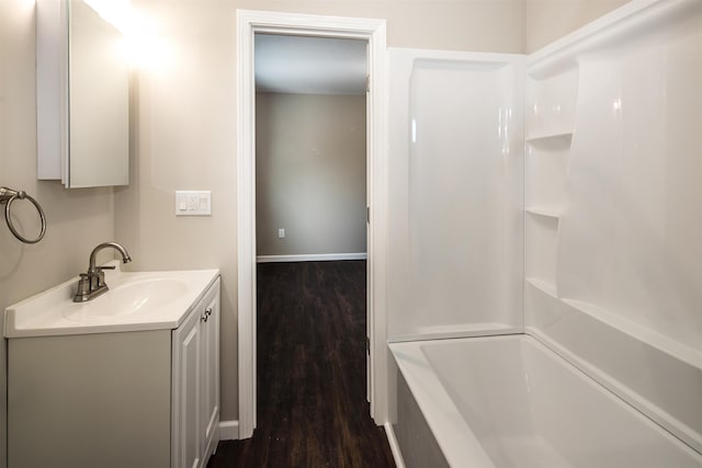 bathroom with hardwood / wood-style floors, vanity, and shower / bathing tub combination