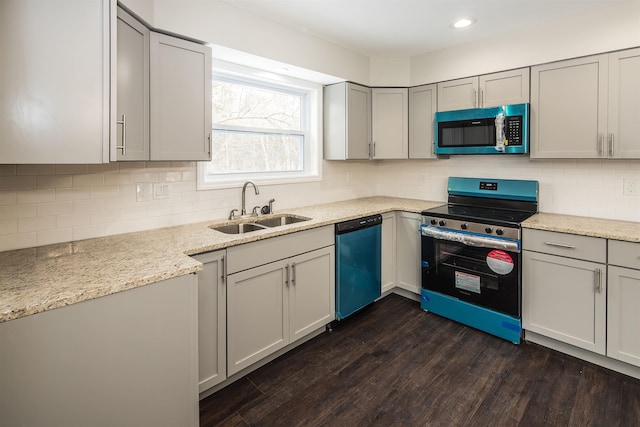 kitchen featuring dark hardwood / wood-style flooring, sink, gray cabinets, and stainless steel appliances