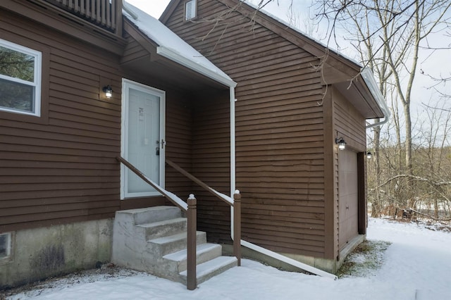 view of snow covered property entrance