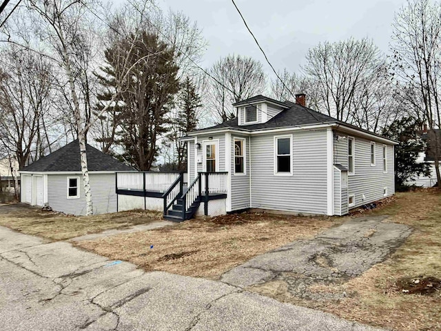 view of front of house featuring an outdoor structure and a garage