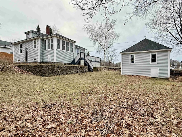 view of side of home with a yard