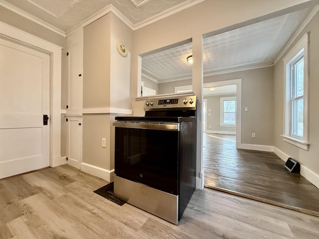 kitchen with ornamental molding, stainless steel range with electric cooktop, and light hardwood / wood-style flooring