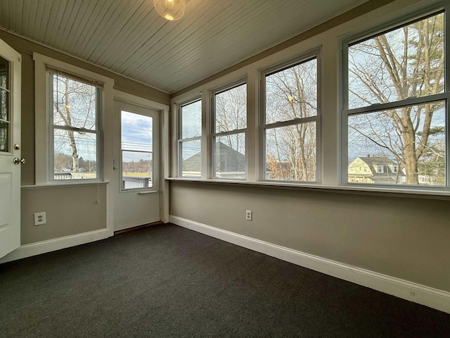 unfurnished sunroom featuring wooden ceiling and a healthy amount of sunlight