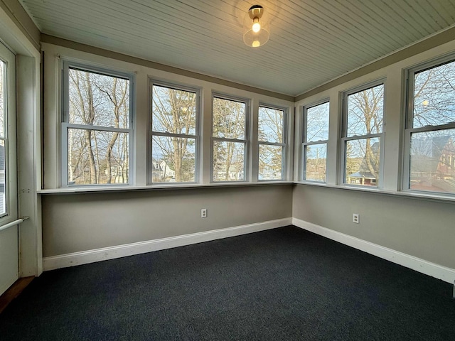 unfurnished sunroom with wood ceiling