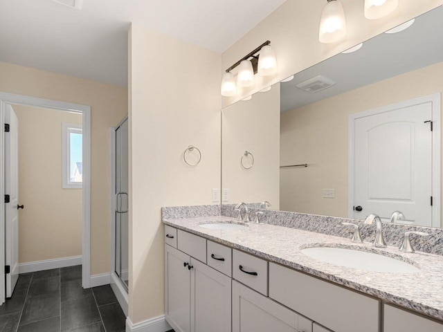 bathroom featuring tile patterned flooring, vanity, and an enclosed shower