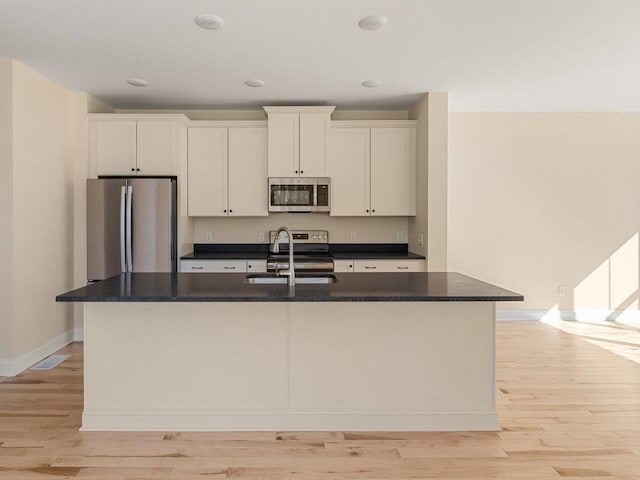 kitchen featuring light hardwood / wood-style floors, white cabinetry, sink, and appliances with stainless steel finishes