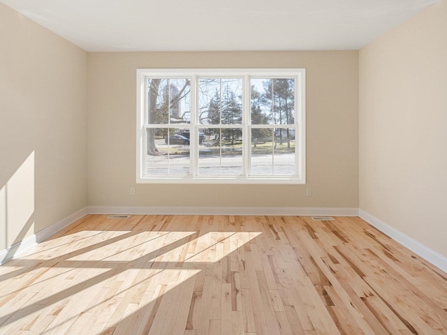 spare room featuring light hardwood / wood-style floors