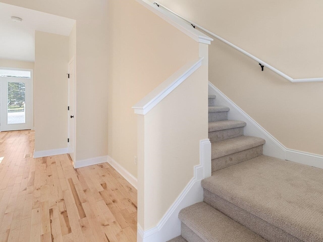 stairs featuring wood-type flooring