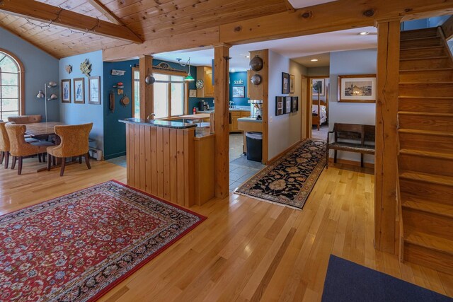 874 Vt Route 100, Ludlow, VT 05149 - kitchen with wooden ceiling, hanging light fixtures, vaulted ceiling with beams, ornate columns, and light wood-type flooring