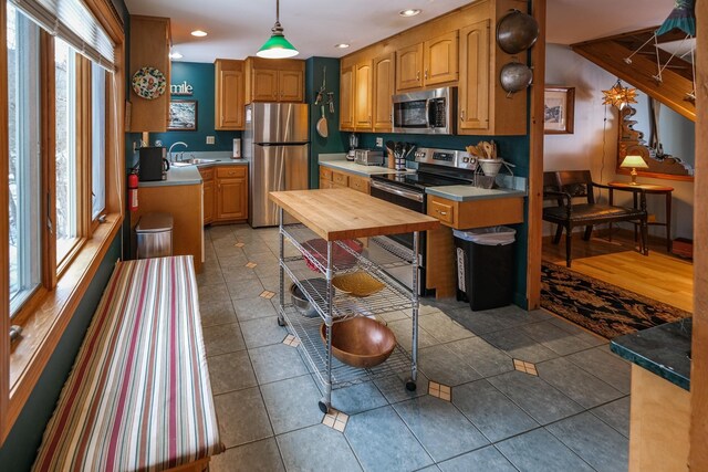 874 Vt Route 100, Ludlow, VT 05149 - kitchen with a healthy amount of sunlight, sink, stainless steel appliances, and decorative light fixtures