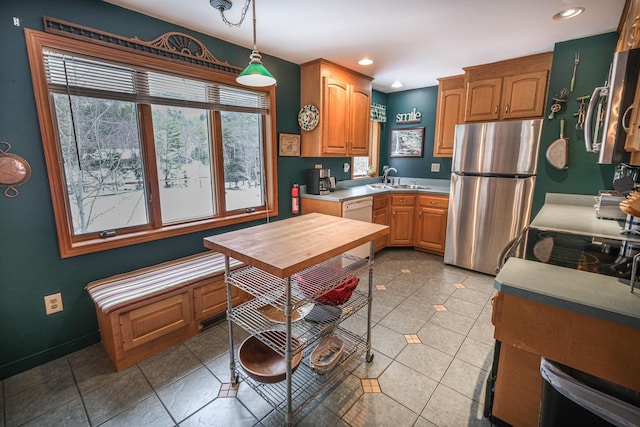 874 Vt Route 100, Ludlow, VT 05149 - kitchen with white dishwasher, sink, light tile patterned floors, decorative light fixtures, and stainless steel refrigerator
