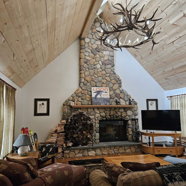 living room with vaulted ceiling with beams, a stone fireplace, a notable chandelier, and wood ceiling