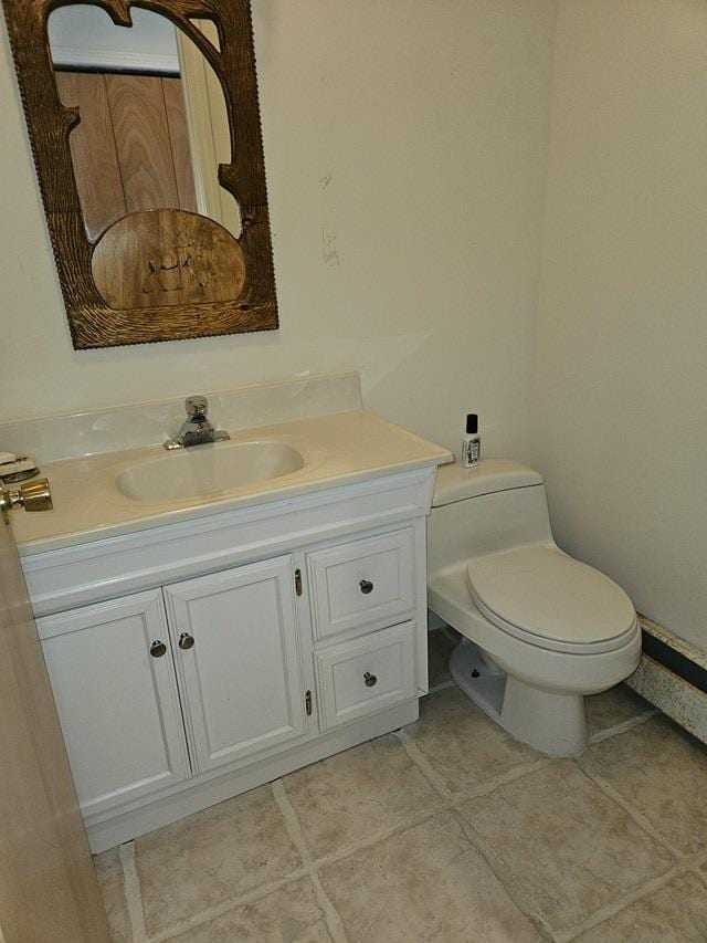 bathroom with tile patterned flooring, vanity, and toilet