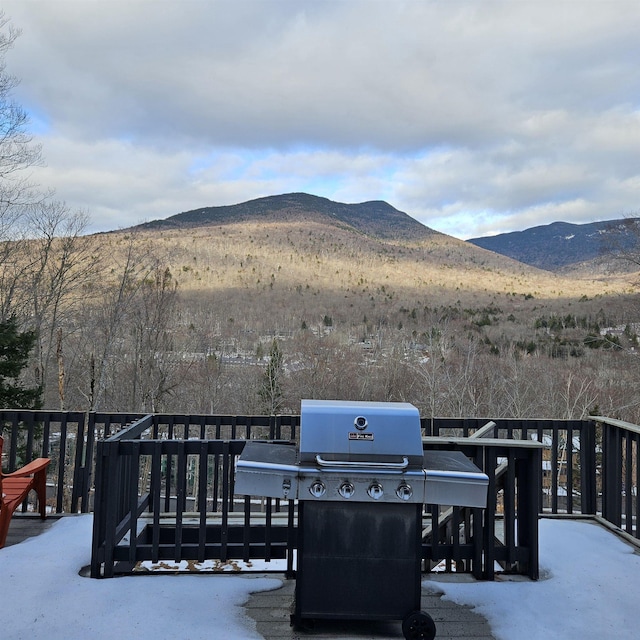 deck with a mountain view and area for grilling