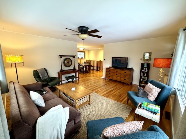 living room with hardwood / wood-style flooring and ceiling fan