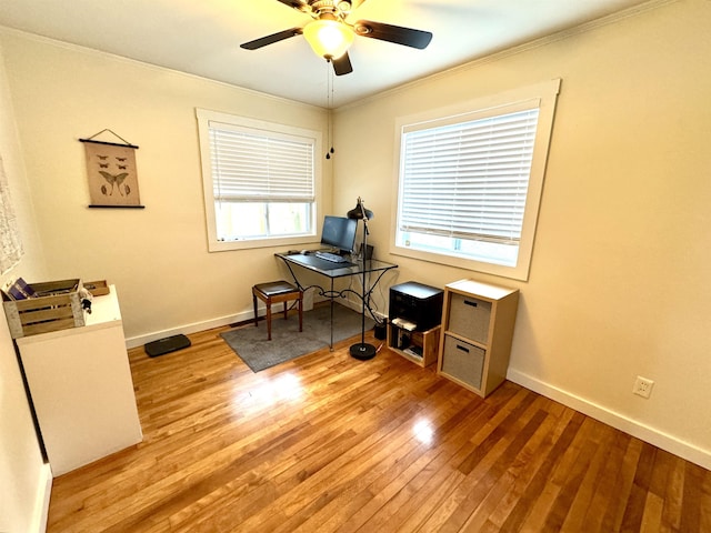 office area with ceiling fan, light wood-type flooring, and ornamental molding