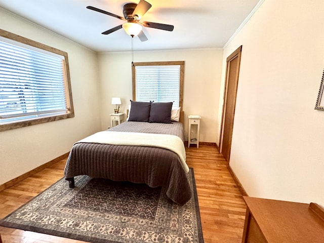 bedroom with ceiling fan, wood-type flooring, and ornamental molding