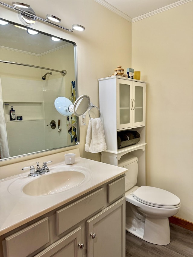 bathroom featuring walk in shower, ornamental molding, vanity, hardwood / wood-style flooring, and toilet