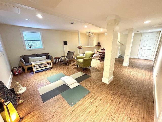 exercise room with wood-type flooring and ornate columns