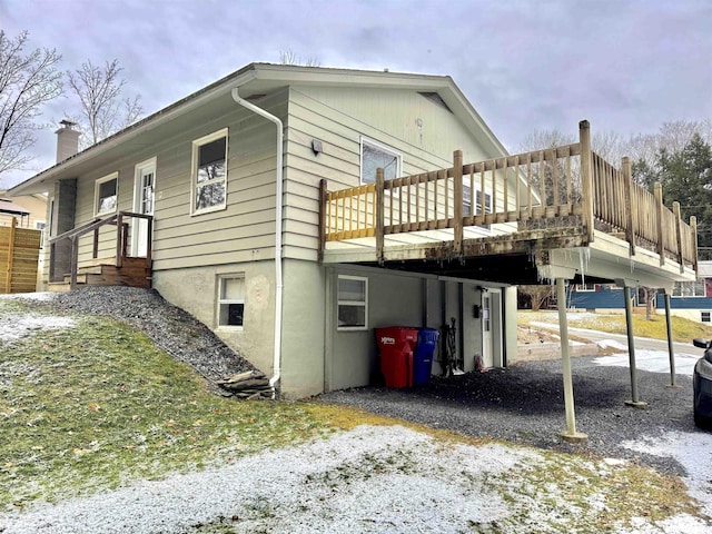 view of side of property featuring a wooden deck