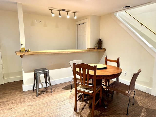 dining space with light hardwood / wood-style floors