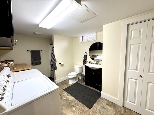 clothes washing area featuring washing machine and dryer and sink