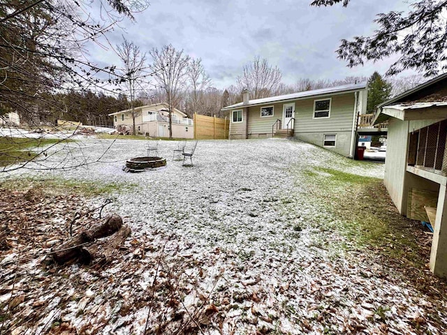 snow covered property with a fire pit