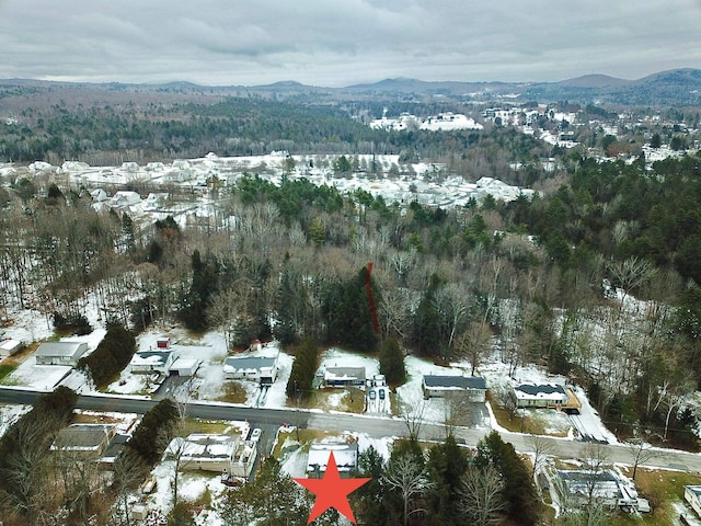 snowy aerial view featuring a mountain view