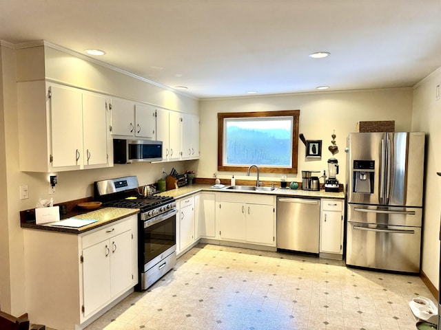 kitchen with white cabinets, ornamental molding, sink, and appliances with stainless steel finishes