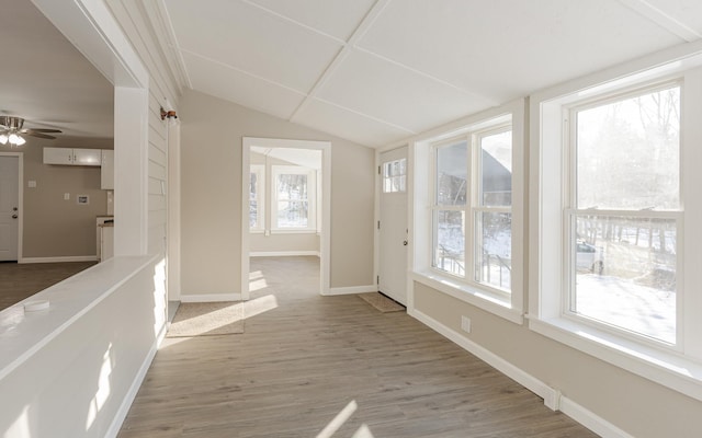 interior space with plenty of natural light, wood-type flooring, and lofted ceiling