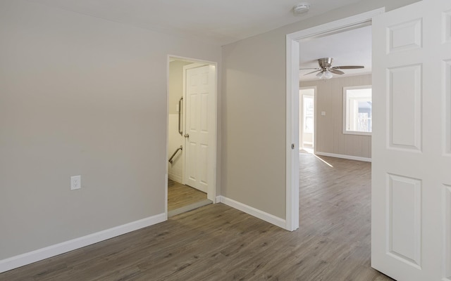 empty room with dark hardwood / wood-style floors and ceiling fan