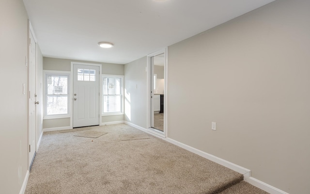 view of carpeted foyer entrance