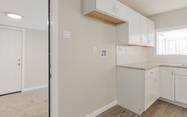 kitchen with white cabinets and light hardwood / wood-style floors