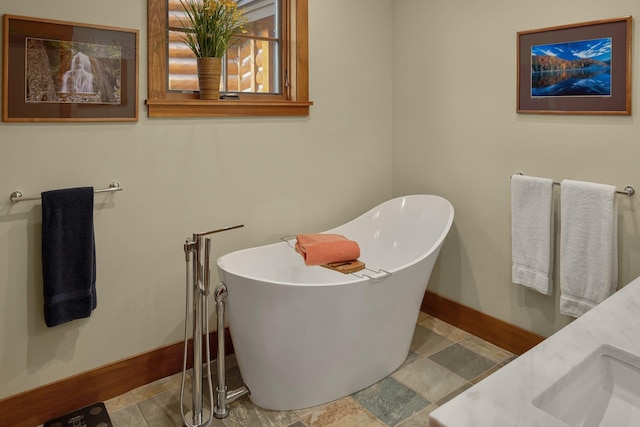 bathroom with a washtub and sink