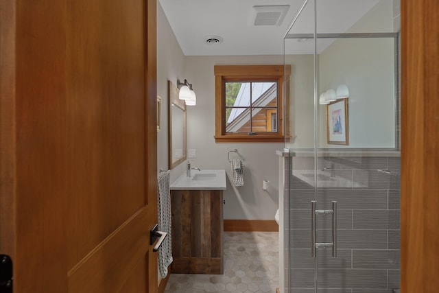 bathroom with tile patterned floors, vanity, and a shower with shower door