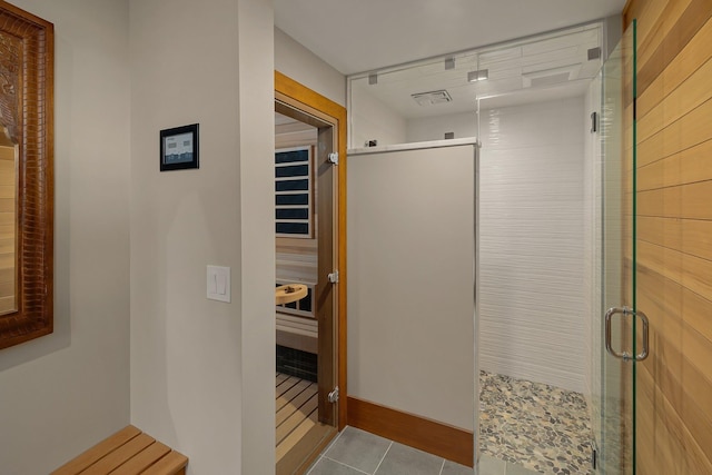 bathroom with tile patterned floors and an enclosed shower