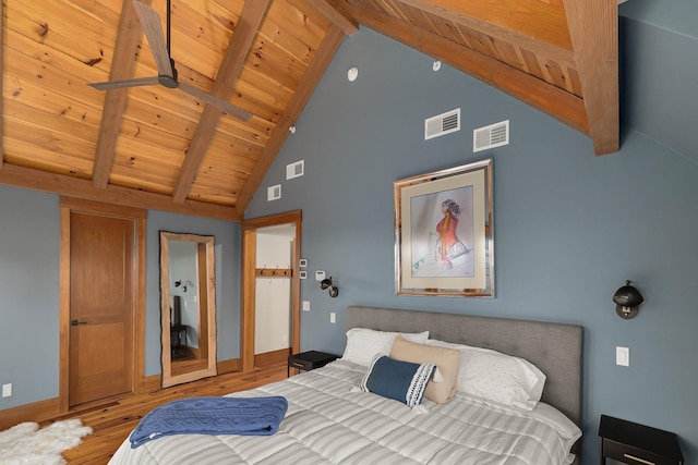 bedroom with beam ceiling, high vaulted ceiling, wood ceiling, and wood-type flooring