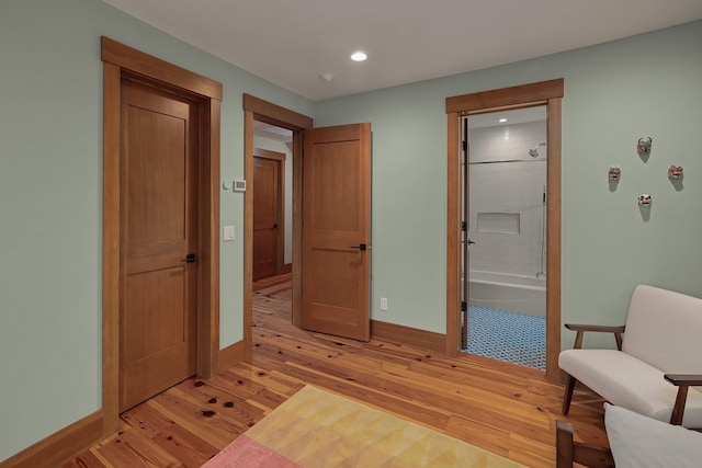 bedroom with light hardwood / wood-style floors and connected bathroom