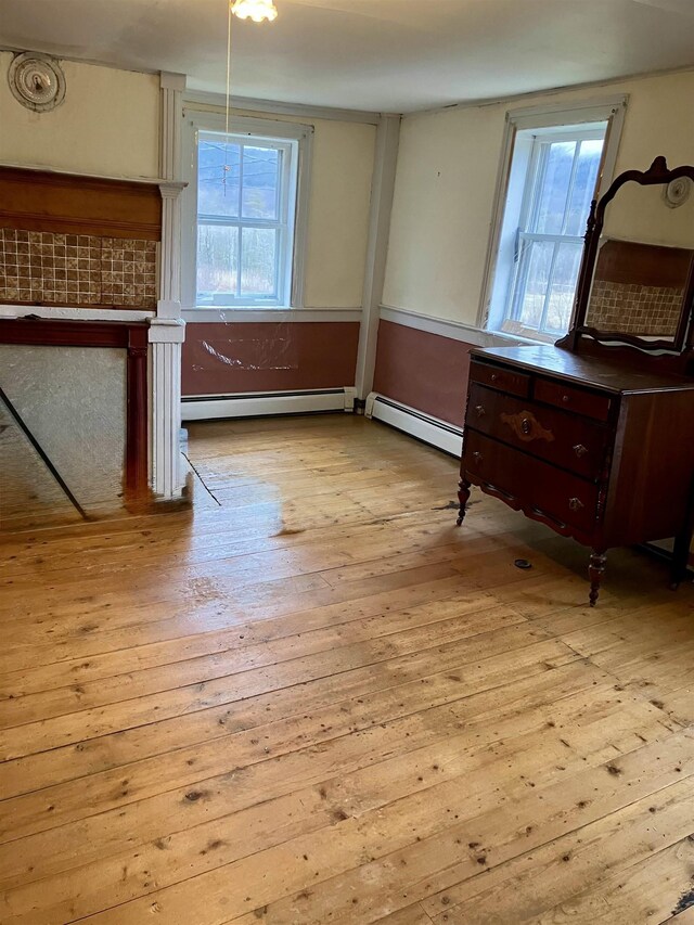 622 S Main St, Danby, VT 05739 - dining area with light wood-type flooring and a baseboard radiator
