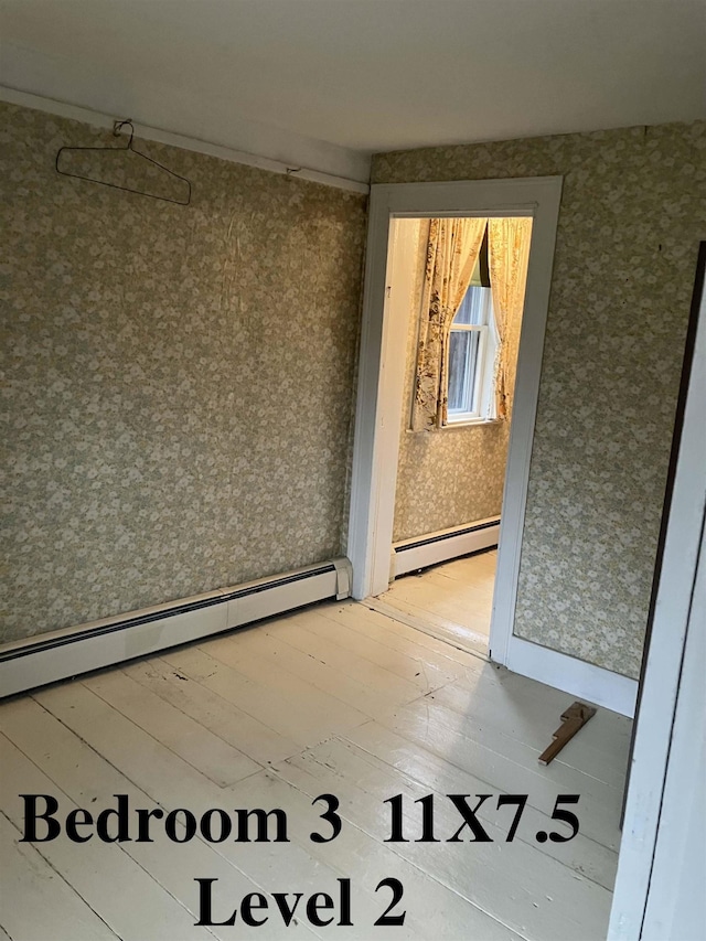 622 S Main St, Danby, VT 05739 - empty room featuring hardwood / wood-style flooring and baseboard heating