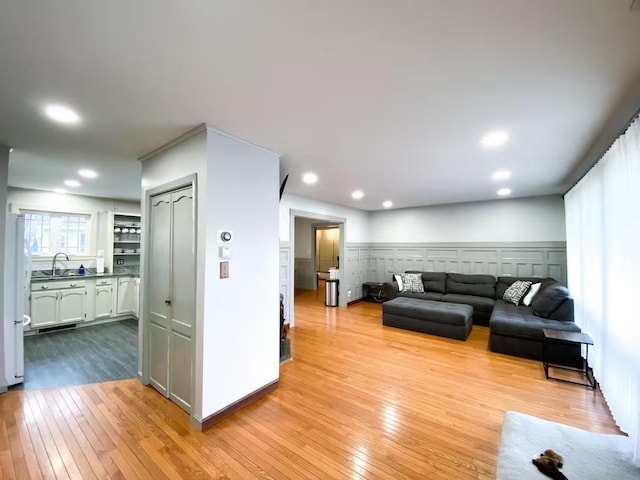 living room featuring light hardwood / wood-style flooring and sink